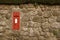 Red Postbox in English Village Wall