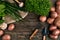 Red potatoes on burlap, garlic with greenery and a garden spade and rake on a wooden brown background