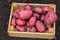 Red potatoes in a wooden box