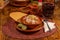 Red pozole with lettuce, oregano, onion, grated radish, toast and lemon. Typical Mexican food with  Jamaican water.