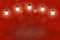 red pretty shiny glitter lights defocused bokeh abstract background with light bulbs and falling snow flakes fly, celebratory