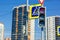 Red prohibition signal of traffic light on the background of high-rise buildings