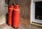 Red propane cylinders outside a house