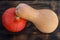 Red pumkin and yellow calabash on dark brown wooden background