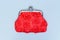 Red purse on a grey background. Red wallet for coins