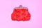 Red purse on a pink background. Red wallet for coins