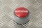 Red Push Button Labeled `Nuclear` on Aluminum Diamond Plate Back