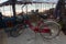 Red pushbike near beach umbrellas.