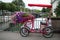 red quad bicycle for rent parked in the street