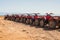 Red quads stand in a row on the shore of the Red Sea. Dahab, Egypt.
