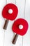 Red racket for ping pong ball wooden background top view