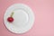 Red radish in a bowl on a pink background