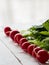 Red radish on a white wooden background.