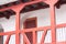 Red railing of an interior balcony with red columns - Medieval architecture