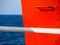 Red railing steps on a ship - high contrast image - white handle bar in the foreground