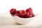 Red raspberies in white china bowl