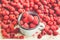 Red raspberries in a box on a blue wooden table. Fresh berries.Detox diet and summer food concept.Toning.Close-up.