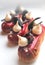 Red raspberry eclairs with meringues and chocolate decorations