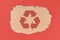 Red recycling arrow symbol on piece of cardboard