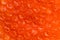 Red red-orange bubble wrap texture.  Plastic for packaging fragile items. Air film abstract background. Close up, top view