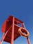 Red rescue tower with a lifeline against the blue sky