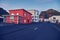 Red residential building on an empty street in Vestmannaeyjar, Iceland