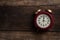 Red retro alarm bell clock on old wooden panels