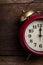 Red retro alarm bell clock on old wooden panels