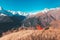 Red retro cable car climbs tourists to the top against the backdrop of the Caucasus Mountains