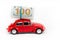 Red retro car with 100 dollar banknotes on white