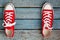 Red retro sneakers on a blue wooden background