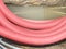Red ribbed protective pipe with steel cable inside