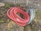 Red ribbed protective pipe with steel cable inside