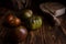 Red ribbed tomatoes on a beautiful wooden cutting board on a wooden background. Low key photo.