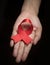 Red ribbon awareness on woman human hand : World aids day