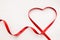 Red ribbon heart love symbol. Happy Valentine\\\'s day. White background with copyspace