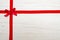 Red ribbon over wooden