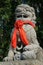 A red ribbon was knotted around the statue of a lion installed in the courtyard of a buddhist temple in Hoi An (Vietnam)