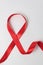 Red ribbon on white background. Aid control symbol. Directly above