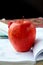 Red ripe apple with English textbooks