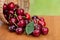 Red Ripe Cherries spilling from basket on a wood table