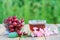 Red ripe cherry fruits with peduncles in glass bowl and cup of t