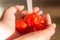 Red ripe cherry tomatoes being washed under water tap