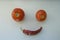 red ripe organic tomatoes and dried hot red pepper on the windowsill in the form of a smiley and emoji