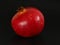 Red ripe pomegranate. Black backrgound