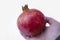 A red ripe pomegranate lies in the person`s hand