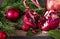 Red ripe  pomegranate,  red Christmas balls ,  fir branches, lollipops , on a dark wooden