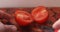 A red ripe tomato is cut