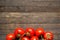 Red ripened tomatoes on wooden background with copy space at top