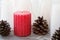 red rippled candle among white blanks candles